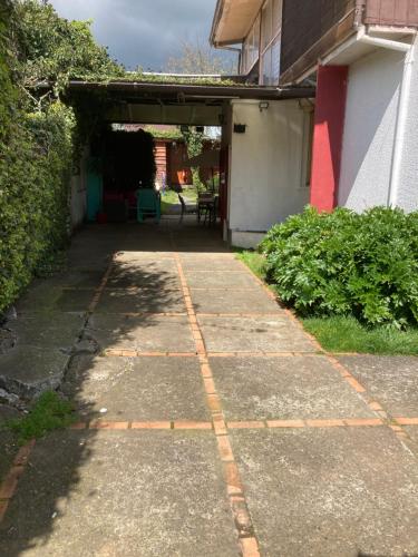 a walkway in front of a building with a garage at Hostal Argentina Osorno in Osorno