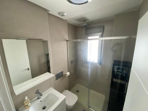 a bathroom with a toilet and a sink and a shower at Green Hills La Zenia-Luxury 3 bed Apartment in Los Dolses