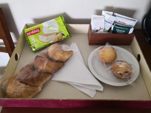 a box with two pastries and a plate of donuts at Los Lagos Hotel in El Calafate