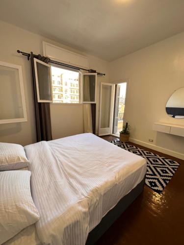 a bedroom with two beds and a window at Economy room in Downtown in Cairo