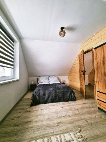 a bedroom with a bed in a attic at Domki U Uli in Wisła