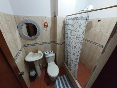 y baño con aseo, lavabo y ducha. en Departamentos de la Costa3, en Machala