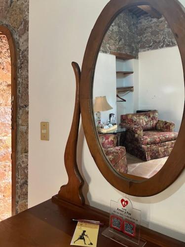 a mirror on a table in a living room at Hotel Amor y Paz in Real de Catorce
