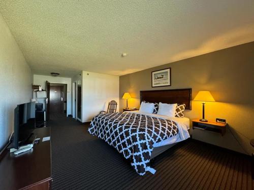 a hotel room with a bed and a flat screen tv at Clock Tower Inn in Berne