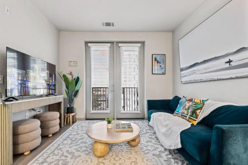 a living room with a blue couch and a table at Tropical Field 1 Bed in Downtown With FREE Parking in St. Petersburg