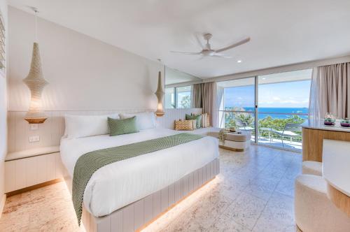 - une chambre avec un grand lit et un balcon dans l'établissement The Elandra, à South Mission Beach