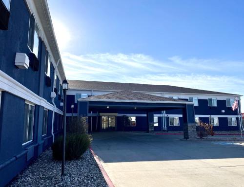a blue building with a parking lot in front of it at Comfort Inn Sioux City South in Morningside