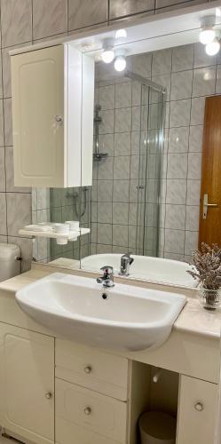 a bathroom with a sink and a mirror and a tub at Villa Adria in Vodice