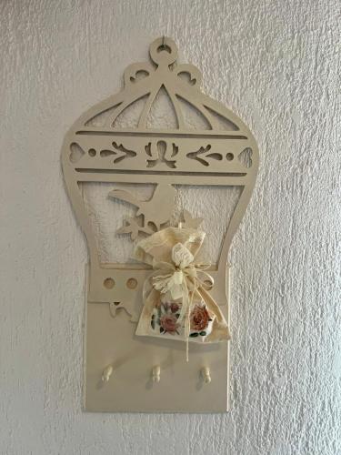 a shelf with a cross and a bouquet of flowers at Villa Adria in Vodice