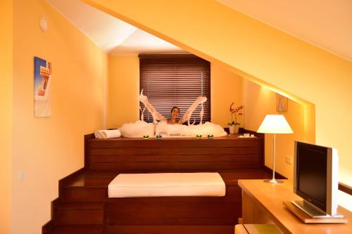 a bathroom with two tubs and a tv in a room at Pestana Sintra Golf Resort & SPA Hotel in Sintra