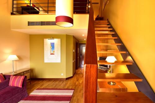 a living room with a staircase and a couch at Pestana Sintra Golf Resort & SPA Hotel in Sintra
