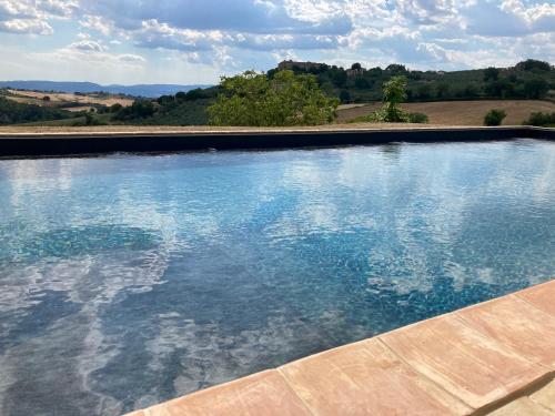 a large swimming pool with a view of the countryside at Agriturismo Portoreschi in Saragano