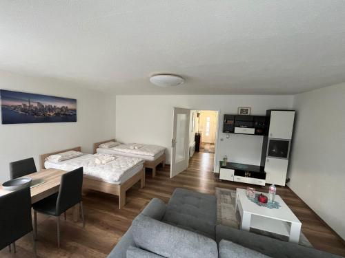a living room with two beds and a couch at Modernes Apartment Saarbrücken in Saarbrücken