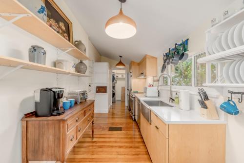 a kitchen with wooden floors and white counters at Old Colorado Inn in Stuart