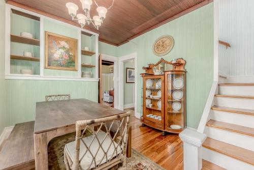 a dining room with a table and a staircase at Old Colorado Inn in Stuart