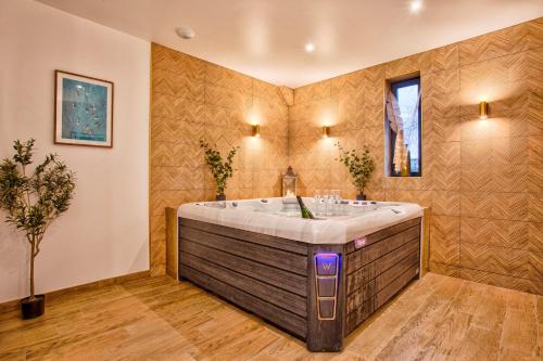 Maison Adeli - SPA- Braséro-Billard- Netflix-Wifi في Dozulé: حمام مع حوض استحمام كبير في الغرفة