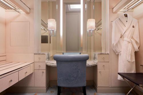 a bathroom with a blue stool in front of a mirror at The St. Regis Kuala Lumpur in Kuala Lumpur