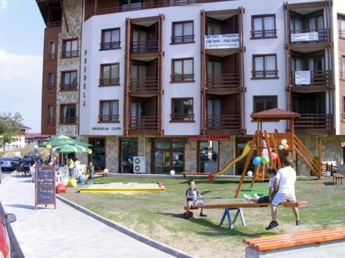 a large building with a playground in front of it at Predela 1 in Bansko