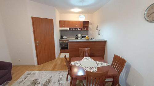 a kitchen and dining room with a table and chairs at Predela 1 in Bansko