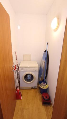 a laundry room with a washing machine in the corner at Predela 1 in Bansko