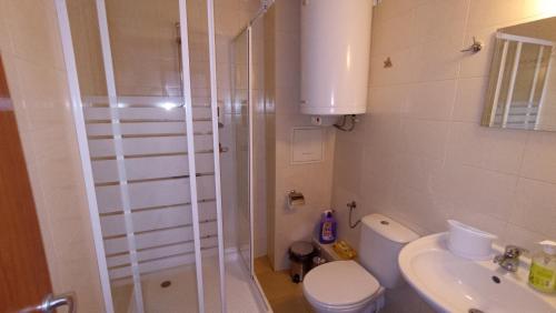a bathroom with a shower and a toilet and a sink at Predela 1 in Bansko