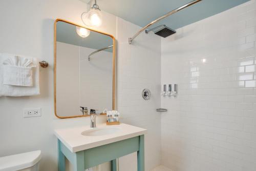 a bathroom with a sink and a shower with a mirror at Fisher Inn Resort & Marina in Islamorada