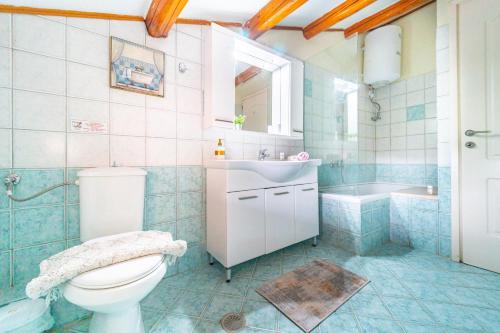 a bathroom with a toilet and a sink and a tub at Maisonette in Corfu Town