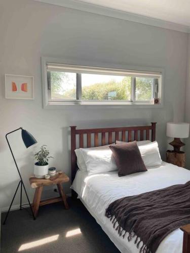 a bedroom with a large bed and a window at Gerringong Bliss in Gerringong