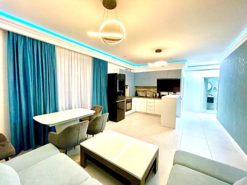 a living room with a couch and a table at Marcony Summerland Apartments in Mamaia