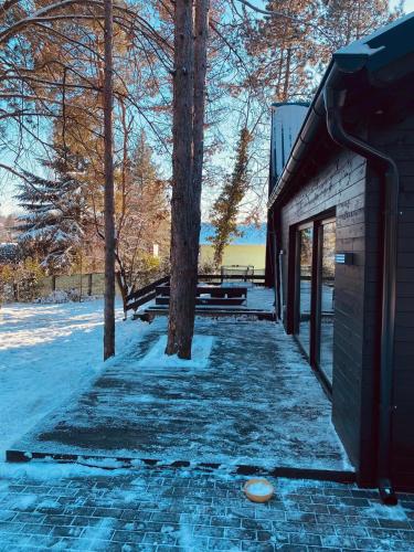 a building with snow on the ground next to trees at Kuća za odmor Vrdnik in Vrdnik