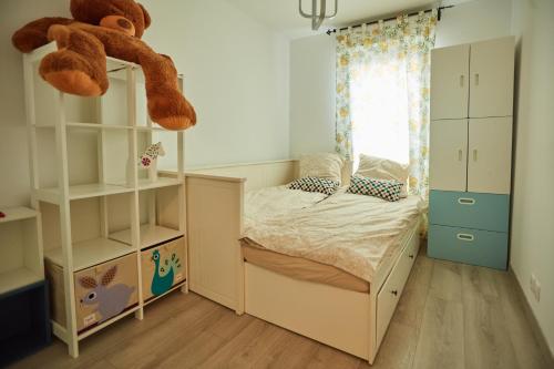 a bedroom with a bed with a teddy bear on top at Appartement adorable et jardin in Villiers-sur-Marne