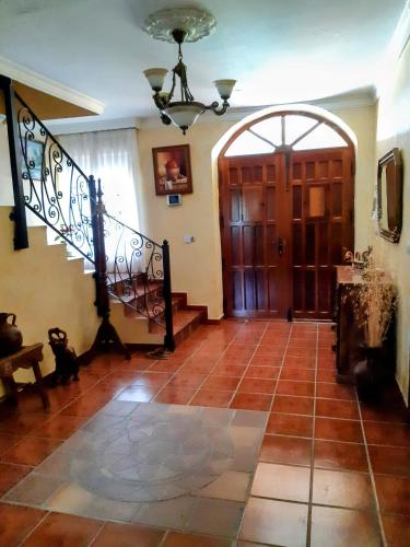 a large room with a staircase and aoyer with a door at La Huerta de Elisa in Villanueva de Duero