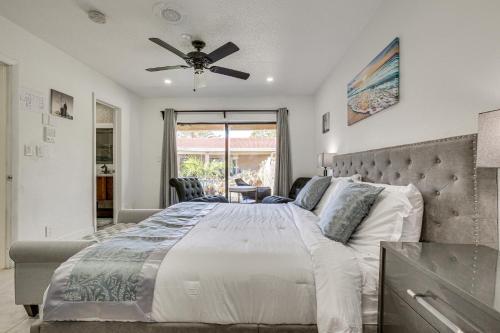 a bedroom with a large bed with a ceiling fan at Spacious Villa in Coral Springs with Pool and Hot Tub! in Coral Springs