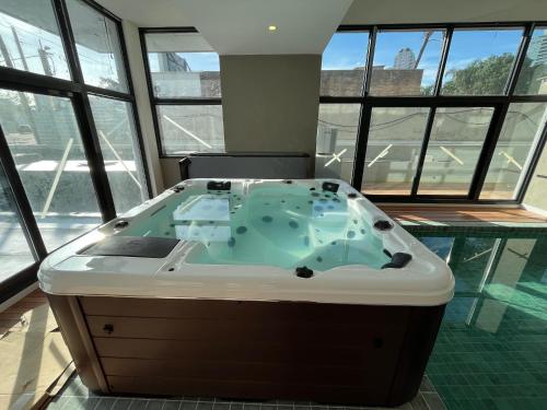 a jacuzzi tub in a room with windows at View 3 in Punta del Este