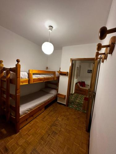 a room with two bunk beds and a hallway at Ca’Dolcino relax in Valchiavenna in Campodolcino