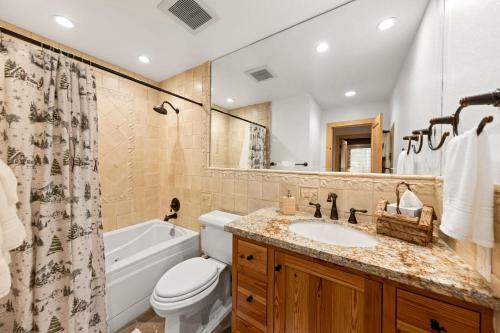 a bathroom with a sink and a tub and a toilet at Rocky Point # 14 Palisades Townhome - Ski Shuttle w Tennis! in Olympic Valley