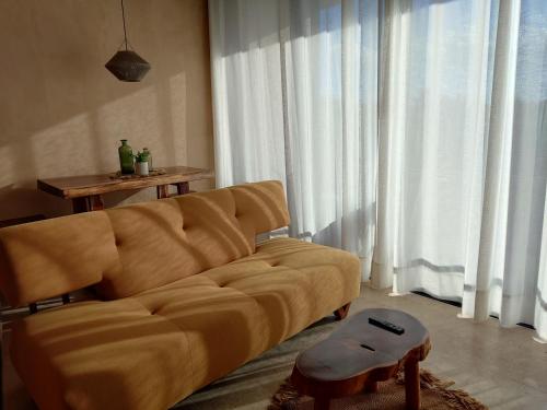 a living room with a couch and a table at Luxury Romantic Getaway - 1 Bedroom - Steps from the Beach - Bahia Tankah Tulum in Tulum