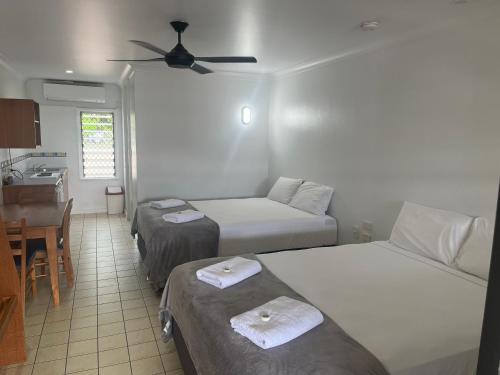 a hotel room with two beds and a table at Lucinda Village in Lucinda