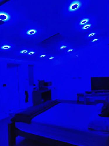 a room with a bed with blue lights on it at Rooms for rent in Solihull in Solihull