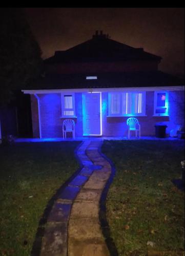 a house lit up in blue and purple at night at Rooms for rent in Solihull in Solihull