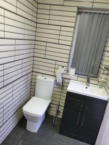 a bathroom with a toilet and a sink at Rooms for rent in Solihull in Solihull