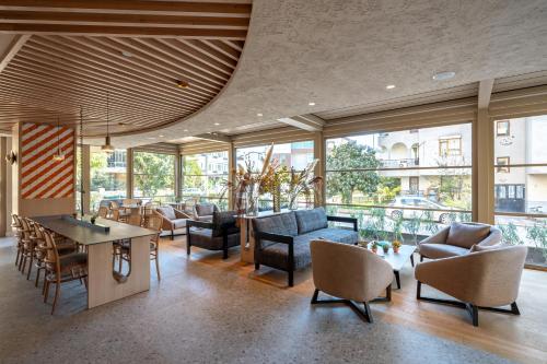 a living room with a lot of furniture and windows at Oli Hotel and Suites in Antalya
