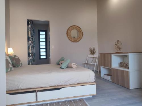 a bedroom with a bed and a dresser in it at Archipel Maimeo in Saint-François