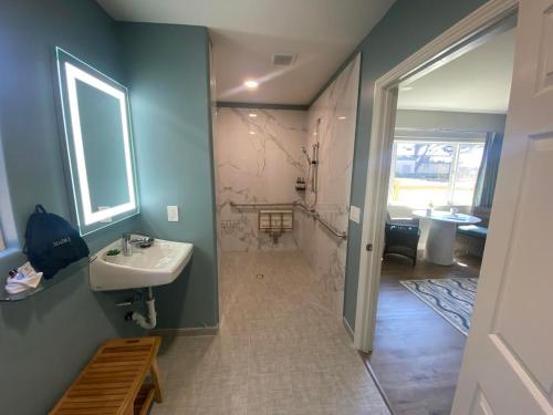 a bathroom with a sink and a shower and a tub at Castle Inn in Cambria