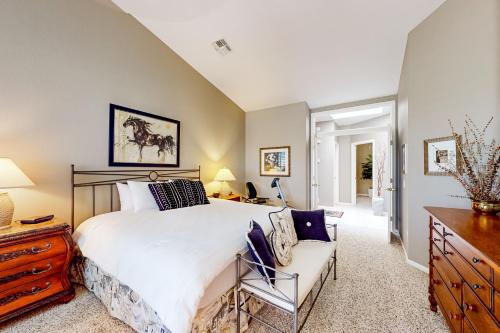 a bedroom with a large bed and a chair at SunnyBrook in Sun Lakes