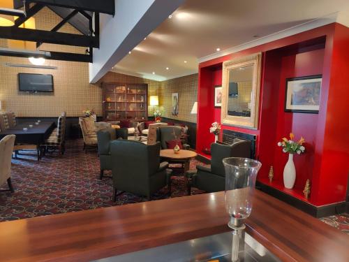 a restaurant with a bar with a table and chairs at Gateway Motor Inn in Masterton