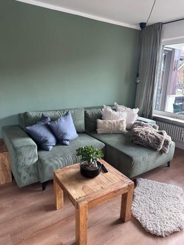 a living room with a green couch and a table at Grünes Stüble Allgäuer Alpen in Sonthofen