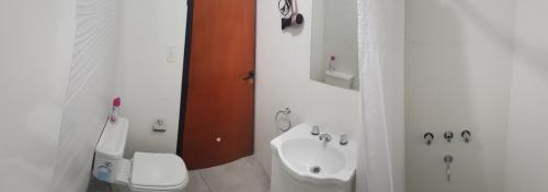 Baño blanco con lavabo y aseo en Munaska C en San Salvador de Jujuy