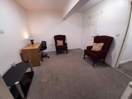a room with two chairs and a desk and a podium at Exclusive Self-contained flat in Middlesbrough in Middlesbrough