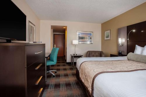 a hotel room with two beds and a flat screen tv at Wingate By Wyndham - Orlando International Airport- Free Hot Breakfast in Orlando